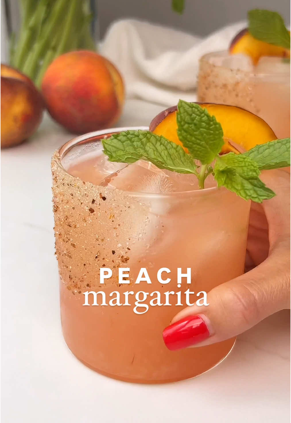 Peach Series Ep. 5 🍑 PEACH MARGARITA 🍹✨ Not to be dramatic, but this Peach Margarita might be the best drink I’ve ever made. Sweet, juicy, a little fancy with elderflower liqueur… and the sugar-tajín rim? Unreal. 📌 SAVE this for your next happy hour!  INGREDIENTS (serves 1): 1 ½ oz tequila 1 oz elderflower liqueur ½ oz lime juice (freshly squeezed) ½ oz simple syrup ½ fresh peach (slightly overripe, sliced) Ice Sugar + tajín (for rim) Mint sprig + peach slice (for garnish) INSTRUCTIONS: Using a pastry brush, paint a little honey on the side of glass. Press  into a sugar + tajín mix. Fill glass with ice. In a cocktail shaker, muddle 1/2 peach until juicy. Add tequila, elderflower liqueur, lime juice, simple syrup, and ice. Shake well until chilled & strain into prepared glass. Garnish with a mint sprig and peach slice. ✨ Sip, savor, and enjoy the peachy magic! #peachmargarita #peachseason #cocktail #drinkrecipe #margarita