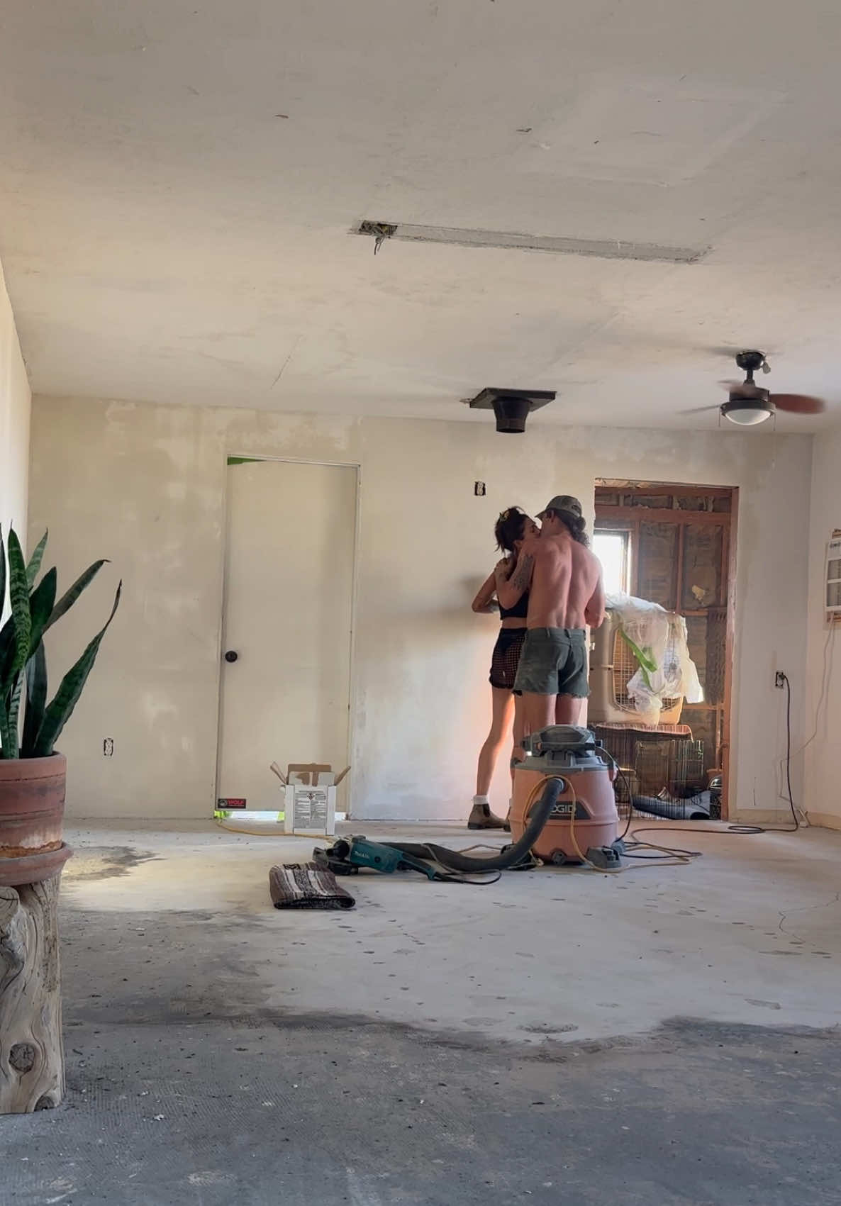 Our first home renovation together 🫶🏼.  Aaron and I decided our indoor project during the heatwave would be an extreme living room renovation 🙃. We have been working away over the last couple months to make our house a home and to be able to actually enjoy our space when the cooler weather comes and host without thinking. I went into depth over on my YouTube channel (link in bio) in episode one of this #livingroommakeover series about the four things you can do to immediately change your space.  1. Smooth out those textured walls  2. Remove that popcorn ceiling  3. Bring your concrete floors back to life by patching and sanding them down  4. Choose a new paint color and set a whole new tone  Although it’s tedious/repetitive, it’s totally worth it. Excited to show you what we’re doing with the ceiling in the next episode!  #homerenovation #roommakeover #livingroom #doittogether  