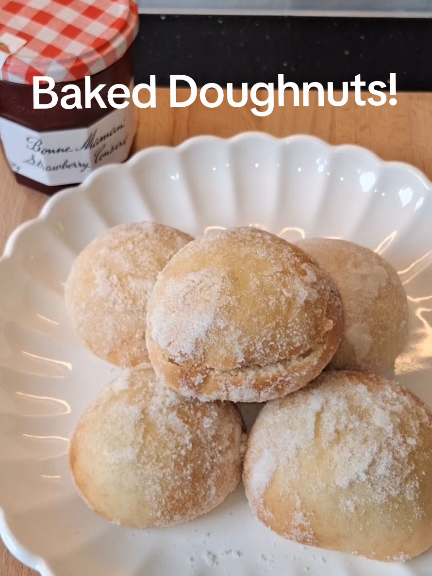 Baked not fried! These doughnuts are so easy to make and taste amazing!! INGREDIENTS (makes 8) For the dough: 25g unsalted butter (plus extra for brushing doughnuts) 300g strong white bread flour 150ml warm semi-skimmed milk (heat in a pan ideally) 1 tsp fast-action dried yeast 50g + 50g caster sugar (divided) 1 large egg Pinch of salt Choose whatever filling you like!   I filled mine with my favourite Strawberry Conserve @Bonne Maman Ireland  and  200ml of whipped double cream - makes 8 STEPS 1. Make the Dough: Rub 25g butter into the flour using fingertips. Mix in yeast, 50g sugar & pinch of salt. Beat egg with warm milk, then add gradually to flour mix.  2.Knead into soft dough on a lightly floured surface for 10 mins 3. Shape into 8 balls, place on greased tray. Cover with clingfilm & leave in a warm hygienic place for 40 mins until doubled in size. 4. Bake Doughnuts: Bake risen dough at 180°C (fan 160°C) for 10–15 mins until golden. Tap base — should sound hollow. 5. Sugar Coat: Brush warm doughnuts in a little melted butter, roll in remaining 50g sugar. Cool on a rack. 6. Fill with your favourite fillings i used a spoonful of strawberry conserve in each with a dollop of whipped double cream. 7. Serve fresh!  #bonnemaman #doughnut #baked #mumsoftiktok #satisfyingvideos 