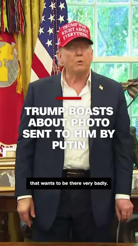 On Friday, President Donald Trump took a moment in the Oval Office to show off a photograph of him and President Vladimir Putin that he says the Russian president sent to him from their Alaska summit.