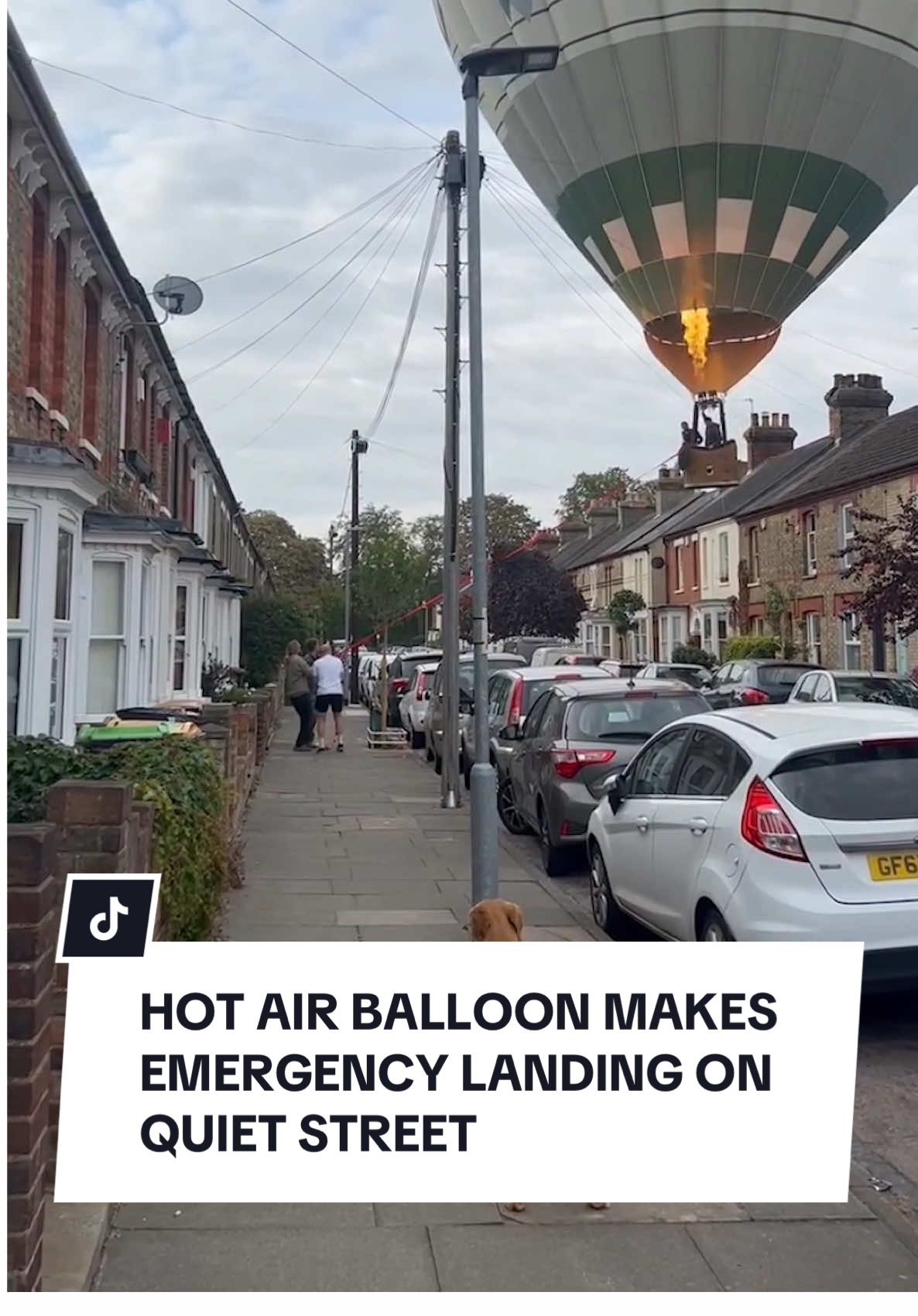 Now this certainly isn’t something you’d expect to come across on your morning walk... A hot air balloon was forced to make an emergency landing on a quiet Bedford street on Saturday morning. Footage posted to social media shows two men dangling beneath it - threw a rope to a group of people on the street below. They managed to guide the basket over rooftops and power lines, for a touch-down in the middle of the road. No one was hurt, and no damage was caused to any nearby buildings or vehicles. #hotairballoon #beford #emergencylanding 