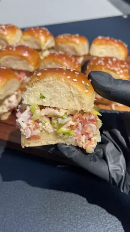 These Chopped Italian Sub Sliders are an easy dinner idea! The garlic butter is a game changer 🧄 Save and share this recipe for later 🔖 Ingredients 🍔 1 bag shredded lettuce  🍔 5-6 Slices of deli ham 🍔 5-6 slices mortadella  🍔 5-6 slices capocollo 🍔 5-6 slices salami 🍔 6-7 slices havarti cheese 🍔 Red onion, sliced 🍔 1 tomato, sliced 🍔 12-15 banana peppers 🍔 1 tsp oregano 🍔 Salt and pepper, to taste 🍔 2 tbsp Mayonnaise 🍔 1 tbsp red wine vinegar 🍔 1 tbsp Italian Dressing Directions: 🍅 Preheat @pitbossgrills 350 F. Spread garlic butter on bottom and top halves of slider rolls. Sprinkle the top rolls with sesame seeds. Toast the rolls for 10-15 minutes. 🍅 Place lettuce on a cutting board and top with ham, mortadella, capocollo, salami, cheese, onion, tomatoes, banana peppers, oregano, salt and pepper. Chop until everything is in small bite-sized pieces. 🍅 Top mixture with mayonnaise, red wine vinegar, Italian dressing and mix to combine. Place mixture on the bottom half of the rolls evenly. Place the top rolls on top of the mixture and slice into individual rolls. #italiansandwich #italiansub #slidersunday #celebritychef