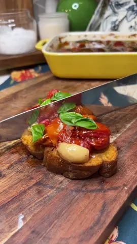 Tomato and Garlic Confit Recipe! Fresh tomatoes and garlic are slow roasted in olive oil with fresh herbs until tender, juicy, and bursting with flavor. This tomato confit is perfect on pasta, pizza, bruschetta, crostini, or simply spread on crusty bread. #tomatoes #confit #EasyRecipe #foodtiktok #tomato 