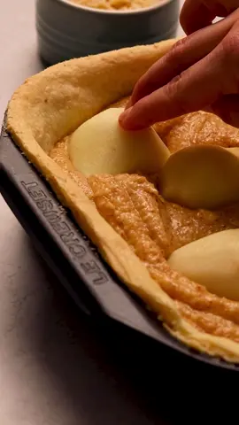 Sweet, nutty and perfectly golden – this Pear Frangipane Tray Tart is a labour of love bound to tempt every palate. Expect many riveting reviews and recipe requests. 🍐 Serves: 8-10 Preparation time: 40 minutes Baking time: 50 minutes 🥧 Ingredients For the Pastry: 450g plain flour 250g cold butter, diced 2 Tbsp icing sugar 80ml milk For the Filling: 375g softened butter 375g caster sugar 450g ground almonds 180g cake flour 9 eggs 1 tsp almond extract 4 large dessert pears, ripe and peeled 50g flaked almonds Icing sugar for dusting 🥧 Method Preheat the oven to 180℃. To make the pastry, place the flour, icing sugar and diced butter into the bowl of a food processor. Pulse until the consistency resembles fine breadcrumbs. Pour the milk over the top and pulse until it comes together into a dough.  Tip onto a floured surface and bring the pastry together, without kneading or overworking. Cover with cling wrap and chill for 15-30 minutes. On a lightly floured surface, roll the pastry into a rectangle large enough to line the base and sides of a #LeCreuset Ovenware 22cm Square Roasting Tin.  Using the rolling pin as a support, lower the pastry into the dish, pressing it gently over the base and into the wall, allowing for an overhang that will be trimmed after baking.  Place in the refrigerator for a minimum of 30 minutes. This should prevent the pastry from shrinking when it goes into the preheated oven.  Remove the dish from the refrigerator and prick the base with a fork. Line with a piece of greaseproof paper and fill with ceramic baking beans, dried beans or rice.  Bake for 12 minutes at 180°C, then remove the paper and beans/rice, bake for a further 5 minutes and remove. Once the pastry has cooled, use a small serrated knife to trim the edges. While the pastry is baking, make the frangipane filling. Place the butter and sugar into a large bowl and cream together with a hand mixer. Add the eggs one at a time, mixing well between each addition. Lastly, add the flour, almond flour and almond extract and mix just to combine.  Spread the fragipane filling evenly in the pastry case.  Peel, halve and core the pears. Push each half, rounded sides up, into the frangipane and scatter with flaked almonds. Bake for 45-50 minutes, until the filling is firm at the centre, and the top is a deep golden brown.  Cool for 15-20 minutes before serving. To serve, dust with sieved icing sugar.