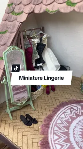 A closer look at my mini lingerie collection 🔥 I made the garment stand using wooden dowels, a long toothpick, and a popsicle stick-she’s not perfect but I think she serves her purpose 🤭 Red corset, black and red panty set and heels made by @MandysMiniWorld  Others I’ve collected over the years from miniature shows💋 #miniatures #dollhouseminiatures 