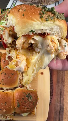 Cheesy Chicken Alfredo Sliders are easy to make and so good!  INGREDIENTS 12 count King’s Hawaiian Rolls Olive oil  1 lb chicken breast, cut into cubes 1/2 tsp each salt and pepper 1 tsp each paprika, onion powder, garlic powder, and Italian seasoning  1 1/2 cups shredded mozzarella cheese  15 oz jar Alfredo sauce 6 pieces of bacon, cooked and crumbled  2 tbsp butter 1/2 tsp each garlic powder and dried parsley  INSTRUCTIONS  Heat a large skillet over medium-high heat. Add 1 lb of cubed chicken to the skillet with some olive oil. Season the chicken with salt, pepper, paprika, onion powder, garlic powder, and Italian seasoning. Stir well and cook until the chicken is fully cooked reaching an internal temperature of 165 degrees F.  Slice Hawaiian rolls in half. Add a layer of shredded mozzarella cheese and top with the cooked chicken. Drizzle some Alfredo sauce over the chicken and top with more mozzarella cheese. Sprinkle on some crumbled bacon and place the tops of the rolls on the sliders.  Mix together 2 tbsp of melted butter with garlic powder and dried parsley. Brush this over the tops of the sliders. Bake the sliders in the oven at 350 degrees F for 10-15 minutes. Serve with warm Alfredo sauce on the side. Enjoy!  #chicken #alfredo #EasyRecipes #sliders 