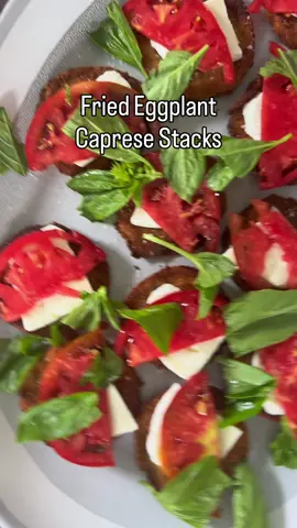 🍆 🍅 Fried Eggplant Caprese Stacks | this take a caprese salad to another level. Perfectly seasoned and crispy eggplant, topped with fresh mozzarella, the best summer tomatoes you can find, basil, and balsamic glaze.  They’re so good I can easily eat a dozen!  2 eggplants cut into 1/4 in disks  2-3 eggs, whisked  Seasoned breadcrumbs, as needed  Fresh mozzarella, sliced Fresh tomatoes, sliced  Basil Balsamic glaze  Salt & Pepper  Oil for frying  Slice your eggplant into 1/4 inch disks. Then set up a breading station with eggs and breadcrumbs, and bread your eggplant.  Slice your mozzarella and tomatoes, and set aside.  Heat your oil over high heat. Once hot, fry your eggplant in batches for 2-3 minutes per side, or until golden brown and crispy. Once done, remove and set aside on a wire rack or a paper towel lined plate, and season with salt.  Plate the fried eggplant, then top with the sliced mozzarella, tomatoes, and basil. Season with salt to taste and a generous drizzle of balsamic glaze.  #friedeggplant #caprese #capresesalad #eggplantcaprese #italianfood   