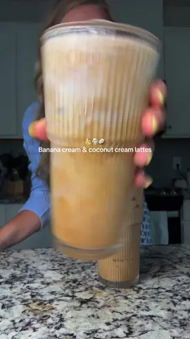 Let’s make two lattes to go! On today’s menu is coconut and banana cream lattes✨🩵 Banana cream latte: 1/2 oz vanilla syrup 1/2 oz bananas foster syrup Pinch of Celtic salt Double shot espresso 6 oz whole milk Ice!! Coconut cream latte: 1/2 oz vanilla syrup 1/2 coconut syrup Pinch of Celtic salt Double shot espresso  6 oz whole milk Ice!! So good! #coffee #coffeetok #latte #coffeetiktok #recipesoftiktok #coffeerecipe #fyp #athomecoffee 