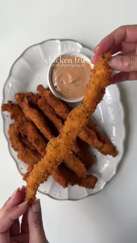 Crispy chicken fries with chicken sauce. Ingredients  For the chicken: 2 lb boneless chicken breast, cut into long strips  Salt to taste 1 tbsp black pepper  1 tsp salt 1 tsp onion powder  1 tbsp smoked paprika powder  2 tbsp oil For the dry batter: 2 cup all purpose flour  Salt to taste  1 tbsp garlic powder  1 tsp onion powder  1 tbsp smoked paprika powder  1 tsp black pepper  For the breadcrumbs: 2 cup panko bread  1 tbsp dried parsley  For the egg wash. 1 egg 1 cup water For the chicken sauce  1 cup mayonnaise  2 tbsp ketchup  1 tbsp Worcestershire sauce  Salt and pepper to taste  1 tbsp garlic powder  1 tsp smoked paprika powder  Method : Pat dry the chicken strips add them into a mixing bowl.  Season with salt pepper, paprika, onion and garlic powder. Drizzle oil , mix well and marinate for about 1 hour in refrigerator. Make dry batter: in a bowl add All purpose flour Salt, pepper, paprika garlic and onion powder . Mix to combine  Make egg wash: In a bowl crack an egg add water and whisk to combine  In a separate tray add bread crumbs and parsley. Mix to combine. Coat the chicken in dry batter then in egg mixture, repeat by coating in dry and egg and lastly coat them with breadcrumbs. Lay flat on a sheet and repeat until all the chicken strips are coated. Make sauce by mix mayonnaise, ketchup, Worcestershire sauce, salt pepper, garlic powder smoked paprika.  Heat oil at 350 F . Carefully drop chicken strips into the hot oil cook for 2-3 min or until internal temp reaches 165 and they turn golden and crispy.  Serve with chicken sauce and enjoy  #fries #crispychicken #Recipe 
