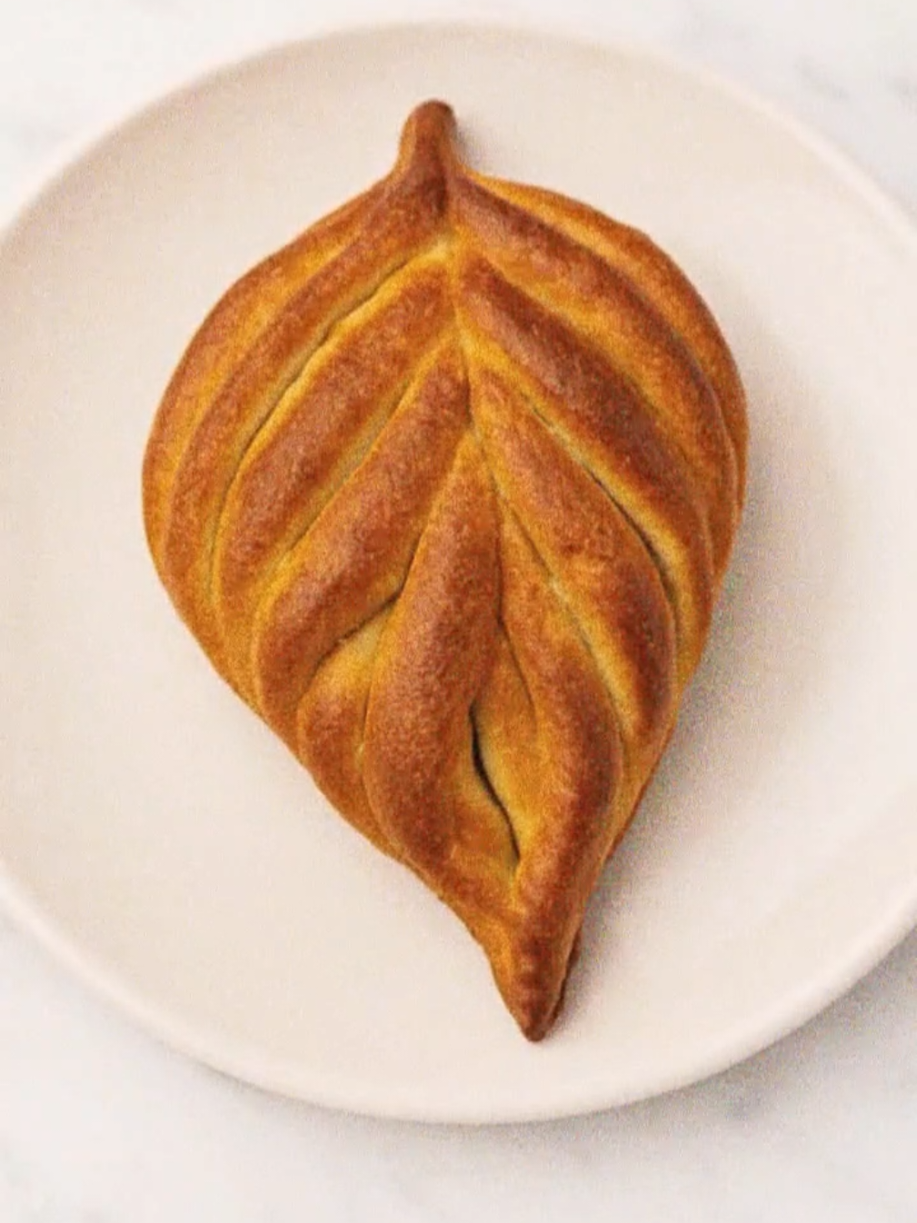 How to shape beautiful dough for bread in my village 😀 🥣Ingredients: 200g yogurt (room temp) 100ml lukewarm water 5 Tbsp (60g) sugar 2 tsp (7g) dry yeast 1 egg+ 1 egg white 2 Tbsp (30ml) vegetable oil 600g flour 1 tsp (4g) salt One egg yolk+1 Tbsp milk Granulated sugar #sweetbread #breadrecipe #breadtok #unitedkingdom #fyp 