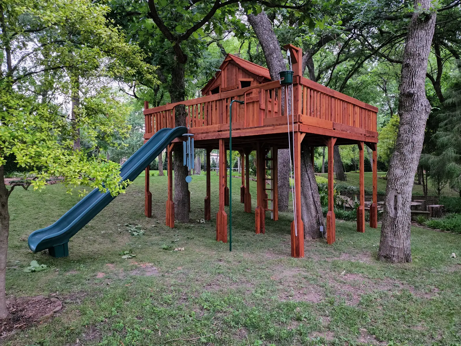 One of our favorite things to do is include as many trees as possible in our sets. It makes it so much fun for the kids! This set also included a secret ladder, which can be pulled up into the cabin as if it's a secret hideout for the kiddos! #swingset #playhouse #treehouse #playset #madeinamerica 