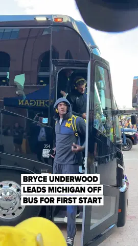 True freshman quarterback Bryce Underwood leads the Michigan football team off the bus ahead of their season opener on Saturday.