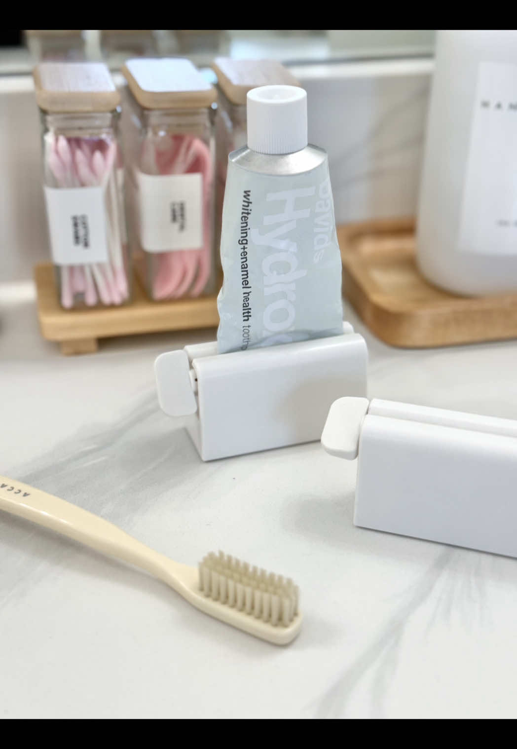 I used to be cool and now I get excited over a toothpaste squeezer 🤭This is one of those tiny swaps that makes your bathroom feel instantly more organized and aesthetic. Proof that the little things really do make a big difference 🪥 #founditonamazon #bathroomessentials #viralfinds #amazonhome #musthaveamazon
