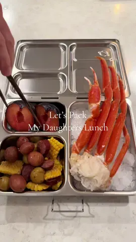 Packed snow crab legs, Cajun corn and potatoes, elk sausage and a black plum plus some melted butter for the crab. 🦀 