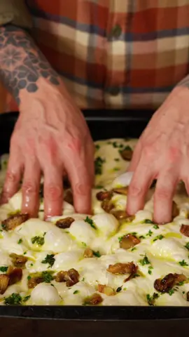 Confit Garlic and Lemon Thyme Focaccia  Ingredients 7g (2¼ tsp) dry yeast 475ml (16 fl oz) warm water (32°C/90°F)  600g (1 lb 5 oz) bread flour 12g (2½ tsp) fine sea salt  60ml (¼ cup) olive oil sea salt flakes Garlic oil 4 whole bulbs of garlic  100ml olive oil 4 sprigs lemon thyme, leaves picked salt and pepper, to season Method Step 1: Prep and proof dough Place the yeast in a large bowl and mix in water until dissolved. Add the salt and stir through. Pour in 20ml olive oil and add the flour. Mix until well combined. Cover the bowl with a tea towel and let it rest for 30 minutes. Step 2: Prep the garlic oil Preheat the oven to 140°C fan forced (285°F). Trim the tops off the garlic bulbs and place in an oven proof dish. Drizzle with the remaining oil and season with salt.  Roast in the oven for 1.5  hours, until very soft and caramelised, then set aside to cool.  Pour the oil off into a medium bowl and mix with the thyme leaves. Squeeze garlic from skins and keep separate.  Step 3:  Stretch and fold the dough  Uncover the dough, then with a wet hand, stretch one corner of the dough and fold it over itself. Repeat 4 times until the dough is completely folded over itself.  Cover again with a tea towel and let it rest for another 30 minutes. Repeat this process three more times. After the fourth and final round of stretching and folding, let the dough rest for 30 minutes.  Step 4: Bake Increase the oven temp to 220°C (428°F). Grease a heavy based 22x33cm baking tray with 20ml olive oil. Transfer dough to tray and spread out to the edges with lightly oiled hands. Cover again and allow to rise for 30 minutes. Remove the tea towel and drizzle the thyme oil over the dough.  Place the garlic cloves over the top of the dough, then use your fingers to create dimples throughout the dough, pressing the garlic cloves into the dough to hide them.  Season with sea salt flakes, then place the bread in the oven. Turn oven down to 200°C (428°F) and bake for 20-25 minutes or until golden brown and cooked through. Transfer bread from tray to a wire rack to cool a little then slice up and serve! #baking #food #Recipe #fyp 