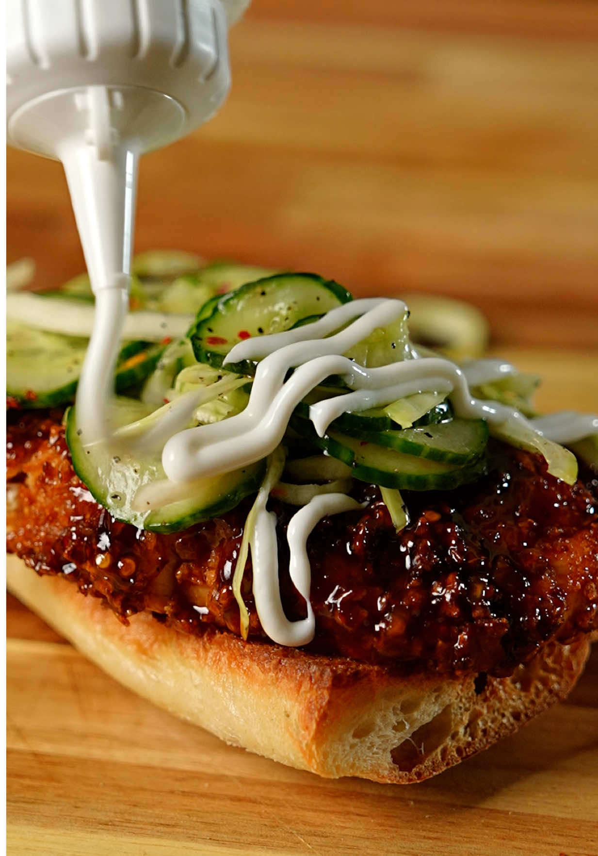 Bourbon chicken crispy and good Yes this is an amazing sandwich and you need to eat it. Also I used whiskey and not actual bourbon because they’re pretty much the same thing anyway. If you are part of the 50% that watches with the audio on then tell me what you think? Sandwiches are the most difficult thing you can make right!?! Recipe  Air fried chicken Take one thigh and dredge it in flour, egg, then crushed corn flakes. Spray with a 0 calorie oil spray and get it in your air fryer at 385 for 16 minutes flipping half way through. Cook till an internal of 165F is reached 197 calories 20g protein 3oz chicken thigh Bourbon sauce In a pan add 2tbsp of light butter, 1/2 cup light soy sauce, 1tbsp brown sugar blend ,1 cup hoisin sauce, 1/2 cup bourbon or whiskey ( cook out alcohol ) crushed red pepper and minced garlic, add warm water if too this to thin  155 calories  Cucumber salad In a container add a whole cucumber and some cabbage, add  lime juice, honey, white balsamic vinegar, avocado oil, salt and pepper mix well 126 calories  Light sour cream spread 41 calories Bread ciabatta  120 calories #bourbonchicken #chickensandwich #airfryer #airfryerrecipes #foodporn