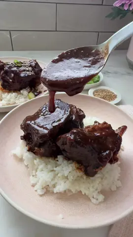 cozy sticky sweet short ribs that are fall-off-the-bone tender. truly the only way to make and serve them. when it gets chilly, the first thing i always want are braised short ribs @beefitswhatsfordinner #BeefYourWay #BeefFarmersandRanchers here's the FULL recipe: Short Ribs: 5 bone-in short ribs Kosher salt + Freshly ground pepper Sauce: 1/2 cup low-sodium soy sauce 6 garlic cloves, grated or minced 1 inch ginger-minced 2 tablespoons rice wine vinegar 1 tablespoon brown sugar 1 tablespoon tomato paste 1 teaspoon gochujang 1 teaspoon ground cumin 2 tablespoons all-purpose flour 2 cups beef stock Sesame seeds, as garnish Green onion, sliced, as garnish 1. Preheat the oven to 350F. 2. In a large Dutch oven, set over medium-high heat. Sear off the short ribs in batches, until browned on each side. Remove from the pot and set aside. 3. While the short ribs are searing, make the sauce. In a large measuring cup, add in the soy sauce, along with the grated garlic, ginger, rice wine vinegar, brown sugar, tomato paste, gochuchanggochujang and cumin. Whisk until smooth. If it’s a little lumpy, it’s ok, it’ll dissolve in the oven. 4. After you remove the short ribs from the Dutch oven, there will be a bit off beef fat in the pot. That’s good! Add in the all-purpose flour and whisk until smooth. Pour in the soy sauce mixture and beef stock. Add the reserved short ribs back to the pot, cover with a lid and transfer to the oven to braise for 2 1/2 hours, until they fall off the bone. 5. Serve over rice. Garnish with sesame seeds and sliced green onion.