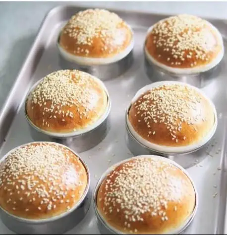 Potato Burger Buns Ingredients 2 cups (250 g) all-purpose flour 1 cup (200 g) mashed potatoes (boiled and mashed without water) 2 tbsp (25 g) sugar 2 tbsp (30 g) butter, softened 1 tsp salt 2 tsp instant yeast ½ cup (120 ml) warm milk (more if needed) 1 egg (for egg wash) 2 tbsp sesame seeds (for topping) Instructions Mix warm milk, sugar, and yeast in a bowl and let it sit until foamy. In another bowl, combine flour, salt, mashed potatoes, and butter, then pour in the yeast mixture. Knead into a soft, slightly sticky dough for about 8–10 minutes. Cover and let it rise until doubled in size. Punch down the dough and divide it into equal portions (about 6–8 buns). Shape into smooth balls and place them on a lined baking tray. Cover and let them rise again until puffy. Brush the tops with beaten egg and sprinkle sesame seeds. Bake in a preheated oven at 180°C (350°F) for 18–20 minutes or until golden brown. Let cool slightly on a rack before slicing.