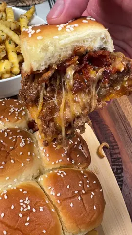BBQ Cheeseburger sliders are an easy weeknight dinner the whole family will love!  INGREDIENTS 12 count King’s Hawaiian Rolls 1 lb ground beef 1/2 tsp each of salt and pepper 1 tsp each of garlic powder, onion powder, and smoked paprika   1 tbsp minced garlic  2 tbsp BBQ sauce  Pepper jack cheese slices Shredded colby jack cheese   Crispy fried onions  6 pieces of bacon, cooked and crumbled  2 tbsp melted butter  Sesame seeds  INSTRUCTIONS Preheat your oven to 350 degrees F.  Cook 1 lb of ground beef in a skillet over medium-high heat. Season with salt, pepper, garlic powder, onion powder, and smoked paprika. Once the ground beef is browned, drain any extra grease from the skillet. Add the minced garlic and BBQ sauce. Stir well.  Slice Hawaiian Rolls in half and put the bottom of the rolls in a greased baking dish or on a sheet pan.  Add a layer of pepper jack cheese. Add the ground beef on top of the cheese. Top the ground beef with shredded colby jack cheese, some crumbled bacon, and crispy fried onions. Top with a little bit more BBQ sauce if desired!  Put the tops of the slider rolls on and brush them with melted butter. Sprinkle sesame seeds on top. Bake at 350 degrees F for about 10-15 minutes. Enjoy! #EasyRecipes #appetizers #dinner #cheeseburger 