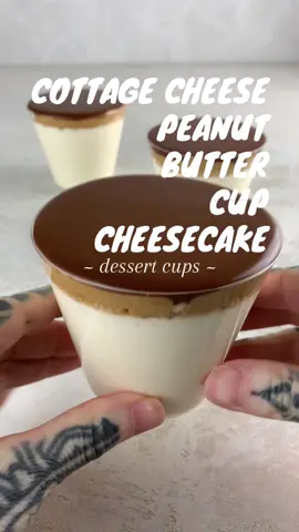 COTTAGE CHEESE PEANUT BUTTER CUP CHEESECAKE CUPS 310 calories, 33g protein, 5g fat, 39g carbs This recipe makes 3 servings -Per serving: 310 calories, 33g protein -No bake dessert! Reese’s cup! 24oz container cottage cheese 1 box sugar free pudding mix, cheesecake 1.5 sheets graham crackers 40g PBfit powder  40g sugar free syrup (+ water) 30g cocoa powder  60g sugar free syrup (+ water) •Blend cottage cheese smooth then mix in pudding mix •crush Graham crackers •mix 40g PBfit powder & 40g syrup. Add water until its able to drizzle  •mix 30g cocoa powder & 60g syrup. Add water until its able to drizzle  •pour cheesecake in a cup, add graham cracker then top with peanut butter & chocolate  •serve now or wait overnight for it to thicken! #highprotein #proteindessert #cottagecheese #reeses #cheesecake 