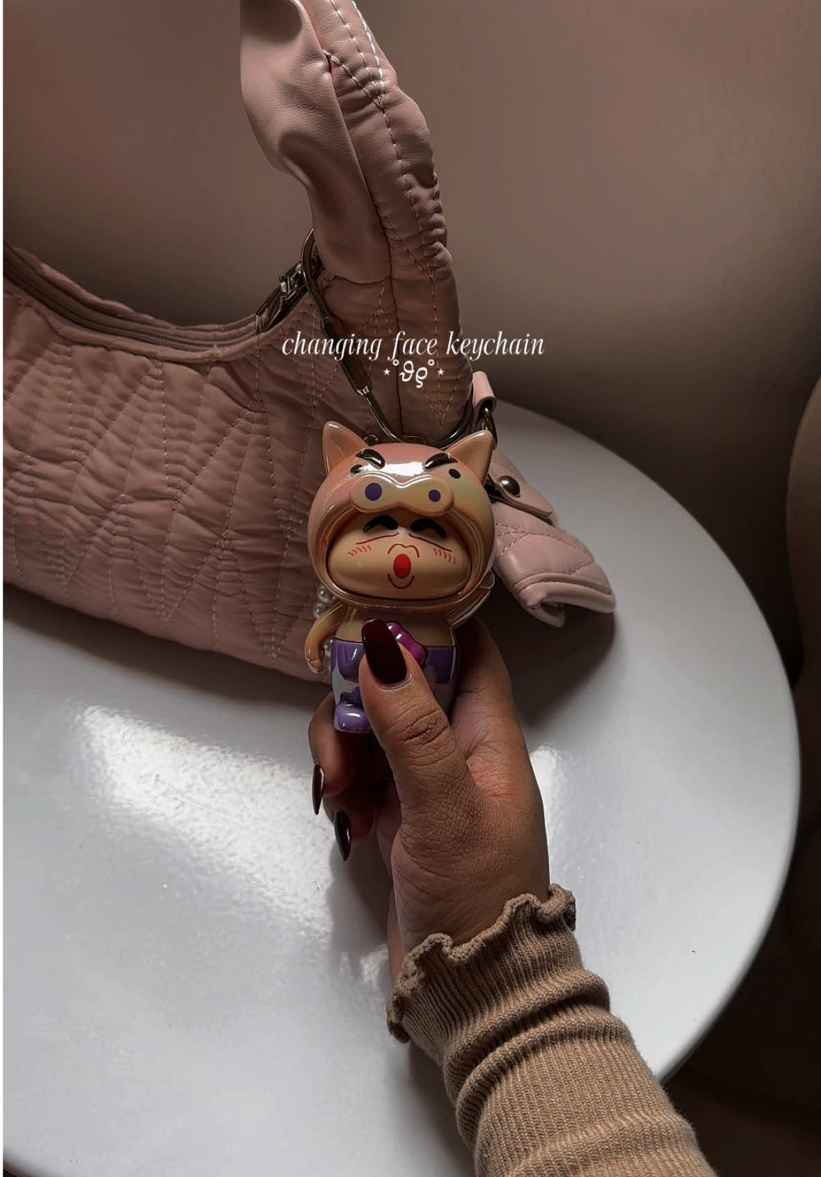 Changing toy doll keychain. 