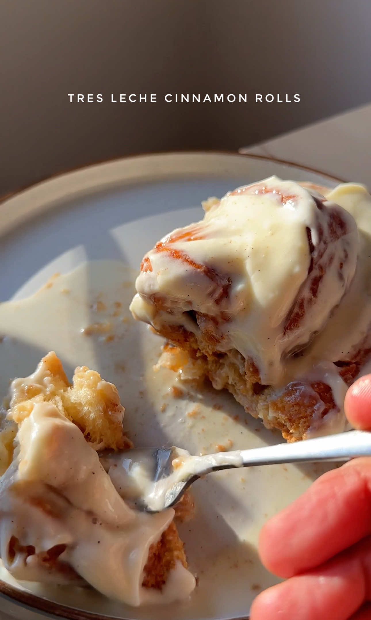 Tres Leches Cinnamon Rolls  Dough Ingredients: For the dough:  450ml milk, room temperature, 10g fast action yeast  150g granulated sugar, 1 tsp salt, 800g plain flour  140g unsalted butter, room temperature   Filling Ingredients: 135g dark brown sugar, 250g butter, room temperature 2 tbsp ground cinnamon Cream Cheese Frosting Ingredients: 1 tbsp room temperature butter, 100g icing sugar  100g room temperature cream cheese, 1 tbsp double cream  1/2 tsp vanilla bean extract  Milk Mixture:  150ml milk, 350ml evaporated milk, 380g condensed milk  Somali Tea spices: cardamom, cloves, ground ginger  • Combine the milk, yeast, sugar, and salt and stir well. Leave to rest for 5mins. Mix in half of the flour, then add the butter and continue mixing. Gradually add the remaining flour and mix until a dough forms. Knead the dough until it no longer sticks to your hands and is smooth. Place the dough in a clean bowl, cover, and let it rise in a warm place for 1 hour, or until doubled in size. While the dough is rising, mix together the brown sugar and the cinnamon ingredients. Turn the risen dough onto a floured surface. stretch and roll it into a large rectangle, about 60cm x 35cm (this doesn’t have to be exact).  Spread the melted butter and then cinnamon sugar evenly over it. Cut into 13 equal sizes lengthways. Then individually roll each one. Place the rolls in a greased oven dish, cover, and let them rise for another 15 minutes or until the gaps have all filled out.  Preheat your oven to 180°C. Bake for 20-25 minutes, or until the rolls are golden making sure to turn the tray halfway.  While the rolls are baking make the milk mixture by heating the milk, condensed milk and evaporated milk with the tea spices. Leave to simmer but don’t let boil. Sieve into a pouring jug and leave to cool.  Remove the rolls from the oven and pour over the milk mixture. While the rolls are cooling, mix together the frosting ingredients until smooth then spread the frosting on top and enjoy!  #cinnamonroll #tresleches #dessert #somali #fyp 