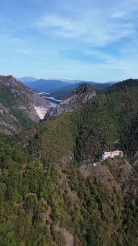 Do you believe stones can remember? In the Argeș Valley they do, and they whisper like old conspirators. Above the river’s restless waters, the ruins of Poenari cling to the cliff like the talons of a predator, skeletal walls that once sheltered the fury of Vlad Țepeș. This is not the polished fantasy peddled elsewhere, but the raw marrow of history, where boyars were impaled as warnings, where prisoners labored until their lungs collapsed, where betrayal was answered with sharpened stakes. It is a fortress less concerned with beauty than with survival, forged in a time when mercy was an unknown word. Beneath it all, Vidraru holds its breath. The reservoir shimmers with an almost unnatural stillness, a sheet of blue pressed into the valley’s chest, reflecting both mountain and cloud. It is not merely a lake but a mirror of contradictions—engineered yet majestic, modern yet ancient in its silence. The waters cover the bones of a forgotten village, but what endures above them is the sense of scale, the awe of humankind daring to bend nature into a vessel of power. Vidraru is not just scenery, it is a stage where ambition and wilderness continue their uneasy dance. And binding this valley together is the road that coils upward toward the sky, a serpent of asphalt and ambition. The Transfăgărășan is no simple highway; it is a passage between worlds, a journey from history’s abyss to the rarefied silence of the high Carpathians. Every turn reveals another secret, every ascent another layer of memory, until you reach a height where air and myth are indistinguishable. Here, legend breathes with the mist, and one cannot help but ask: are we travelers on a road, or are we merely intruders in a landscape that remembers far more than we ever will?  Video by @NaturaRomânească 🇷🇴  [Poenari Fortress, Vlad Tepes, Vidraru Dam, Lake Vidraru, Arges Valley, Medieval Stronghold, Haunted Ruins, Impaler History, Submerged Village, Carpathian Mountains, Gothic Lore, Dark Legends, Mountain Road, Transfagarasan Ascent, Romanian History, Fortress Ruins, Drowned Memories, Valley of Shadows, Historical Myths, Whispering Stones] #romania #travel #Transfagarasan #draculalands