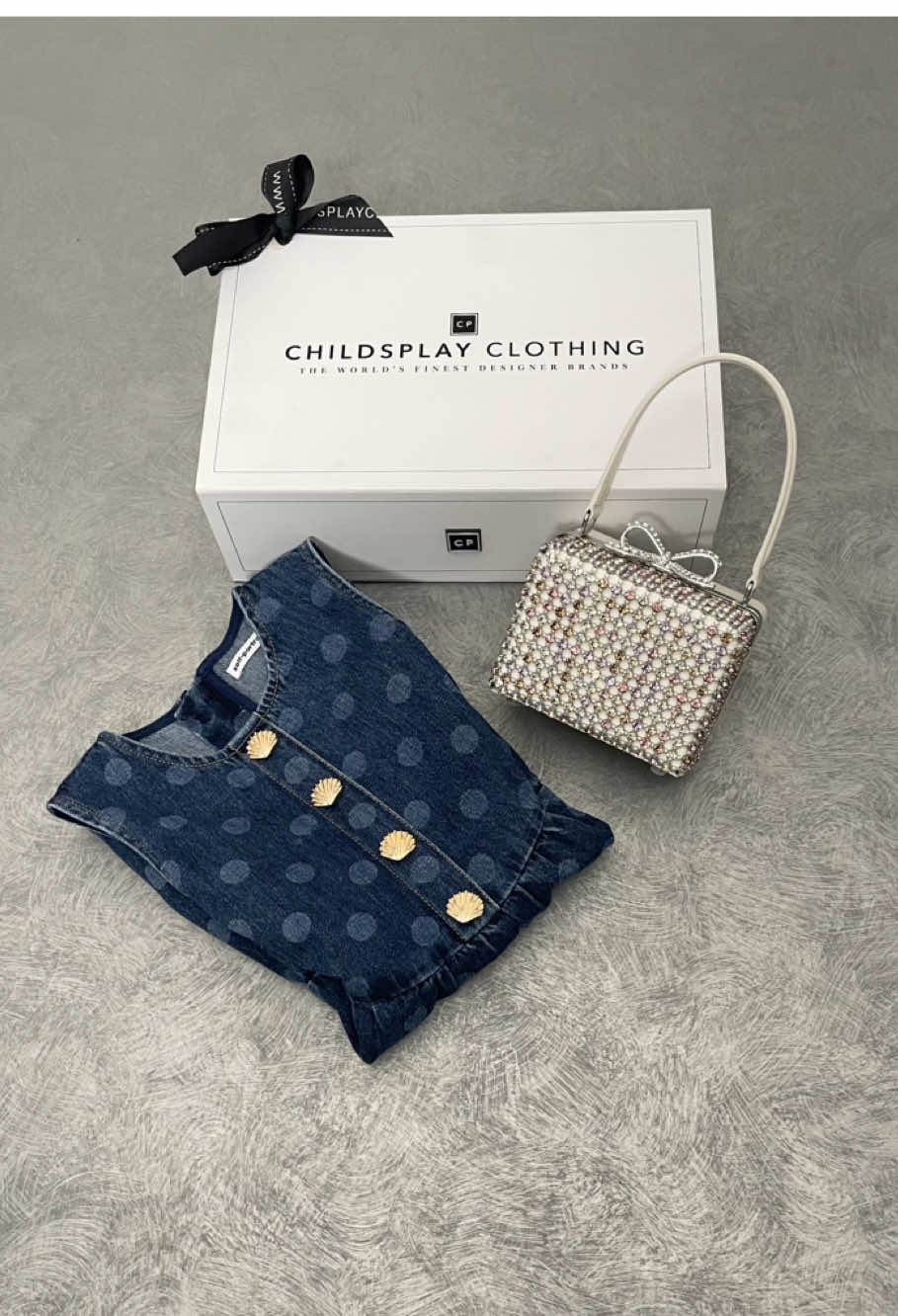 Dots, denim, and a dash of sparkle ✨ The ultimate mini outfit upgrade finished with a crystal micro bag for that wow factor! #ChildsplayClothing #SelfPortrait #LuxuryKidsFashion