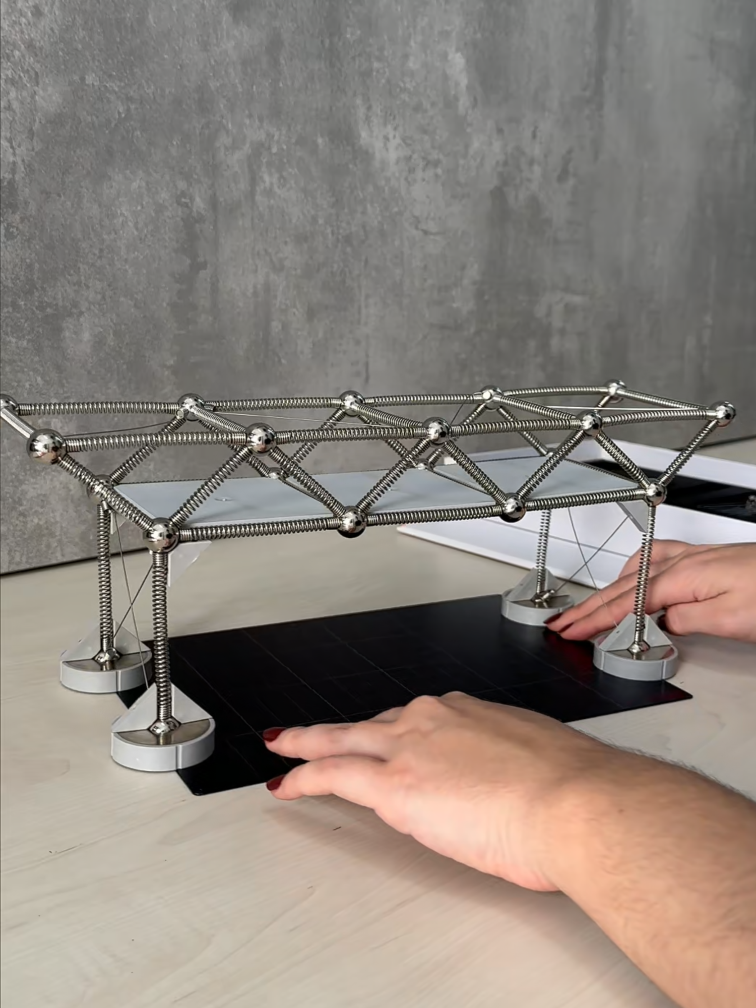 Truss bridges are one of the most iconic examples of how structural geometry ensures efficiency and stability. With Mola 2, you can build and test these structures firsthand, seeing how each bar works together to resist applied loads. - Pontes treliçadas são um dos exemplos mais clássicos de como a geometria estrutural garante eficiência e estabilidade. Com o Mola 2, é possível montar e observar o comportamento dessas estruturas de perto, entendendo como cada barra contribui para resistir aos esforços aplicados.
