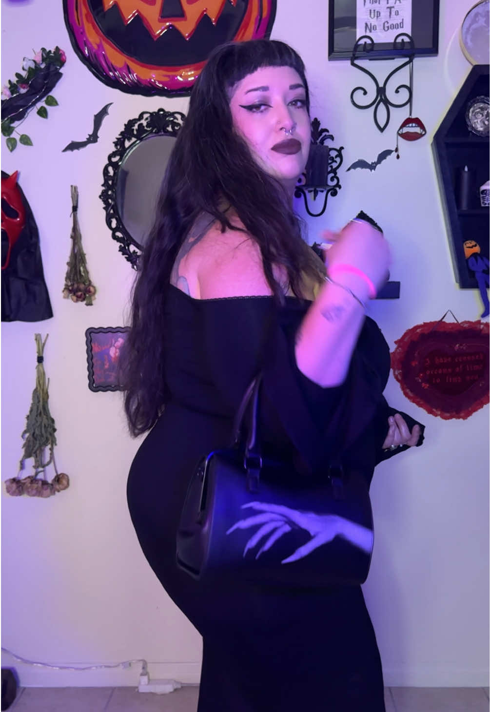 The Shadow Hunter Bag (the bag is grey scale but my lighting makes it look colorful) get your hands on this bag before it sells out! No AI art was involved in this design. I’m also wearing the Drusilla dress and hot damn she’s a keeper!  #plussizegoth #gothlatina #shadowhunter #morticia #alternativefashion 