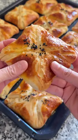 Bless the hands that prepared this 🙏 Ingredients 	•	1 cup water 	•	1 cup milk 	•	1 tablespoon sugar 	•	1 small tea glass vegetable oil 	•	1.5 teaspoons salt 	•	Half a packet of instant yeast 	•	2 egg whites (for the dough), yolks reserved for brushing on top 	•	5 to 5.5 cups flour (to get a medium-soft dough) Instructions 	1.	Knead the dough with the ingredients. 	2.	Without waiting, divide the dough into 18 equal pieces. 	3.	Cover tightly so no air gets in, and let rest for 10 minutes. 	4.	Roll out each piece into the size of a small tray. 	5.	Brush with a mixture of vegetable oil and butter, then fold as shown in the video. 	6.	Add filling — I used cheese, but you can use any filling you like. 	7.	Brush the tops with egg yolk. 	8.	Bake in a preheated oven at 180°C for 25–30 minutes.  #cake #dessert #food #bakery     
