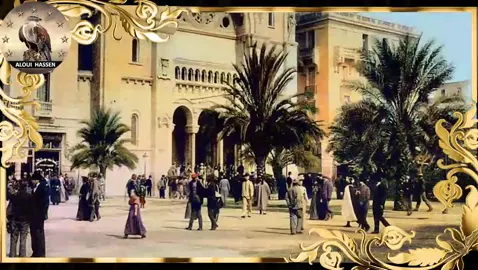 Cette scène illustre une époque où Tunis était un carrefour multiculturel, sous le protectorat français. La cathédrale, inaugurée en 1897, était un point de rassemblement emblématique pour la communauté chrétienne et européenne de la ville. Les palmiers encadrent la place, illustrant le charme méditerranéen de Tunis. De nombreux hommes portent des gilets et des chapeaux, tandis que les femmes sont vêtues de robes longues, typiques du début du 20e siècle.