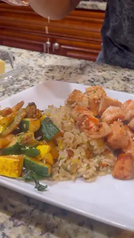 Hibachi at home!!! Very easy to make and inexpensive. Plus it Stretches!  I used chicken, shrimp and Salmon for my protein. Broccoli, Zucchini and squash for my veggies. For my rice simply day old rice, eggs, onions, green onions, carrots, garlic butter and soy sauce. Pull out your complete 4-pack of seasonings for this one. Link in my bio🤗 Watch me make this step by step on my YouTube channel. #Foodie #hibachi #homecooking #fyp 