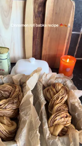 Replying to @heartily CINNAMON ROLL BABKA RECIPE: Makes 2 babkas  Ingredients : Dough: 550g of strong white flour  100g caster sugar  2.5 tsp instant yeast  4 eggs  125ml whole milk 1tsp. Salt  150g softened butter  Filling:  200g softened butter  250g dark brown sugar  1tsp salt  2.5 tbsp ground cinnamon  Syrup:  60g caster sugar  75g water  In a stand mixer, mix the dry ingredients for the dough. Then add the eggs and milk and mix with a dough hook on a low speed for a couple of minutes until a dough starts to form. Then add the butter a spoonful at a time. Wait until the last spoonful is fully mixed in until adding the next one. Mix for a further 8-12 minutes until the dough becomes sticky but stretchy. Move to an oiled bowl then clingfilm and leave in the fridge overnight. The next day: Add all of the filling ingredients together in a bowl and whisk until it turns into a paste.  Take the dough out of the fridge and out of the bowl onto a clean surface. Cut the dough into two equal parts and set one aside. Roll out the dough into a rough rectangle shape and spread on half of the filling evenly. Roll the dough into a tight log shape. Then, using a sharp knife, cut the log in half lengthways, leaving a couple of inches at the top so the two halves stay connected. Twist the two halves together with the insides showing the filling facing up. Once the whole roll is twisted, add to a loaf tin lined with parchment paper. Repeat this with the other half of the dough from earlier.  Add the two loaf tins to a preheated oven at 170 c and bake for 40-45 minutes.  While they are baking add the sugar and water for the syrup to a saucepan. Bring to a gentle simmer until the sugar is dissolved. Once the babkas are out of the oven, brush over the syrup while they are still hot. #cinnamonroll #babka #autumn #fall #fallbaking #Recipe #