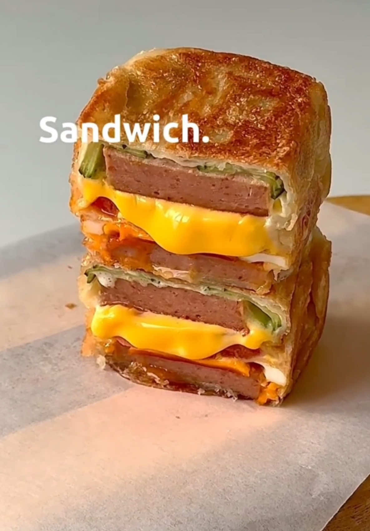 **Craving a quick, delicious meal? Try this Crispy Asian-Style Pancake Sandwich!** **Recipe in short:** 1.  Thinly slice cucumber, tomato, and luncheon meat. 2.  Pan-fry luncheon meat until crispy, then fry an egg. 3.  Take a frozen hand-grabbed pancake (手抓饼), spread with mayonnaise. 4.  Layer cucumber, luncheon meat, cheese, tomato, egg, and more luncheon meat on the pancake. 5.  Fold the pancake around the fillings to create a square. 6.  Pan-fry on low heat until golden brown and crispy on all sides. Slice and enjoy! #food #Vlog #FoodLover #tiktokviral #fyp 