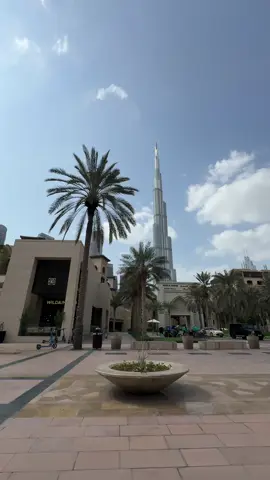 Part - 172 | A Bright Day in the Heart of Dubai 🫠😀✨🫶🥀.  Around 3 PM in Downtown Dubai, the weather was hot but a light wind was moving through the city. The Burj Khalifa was shining in the bright sun, standing tall above everything. The sky was clear, and with the wind blowing gently, the downtown area looked lively and full of energy. #downtown #dubaitiktok #fypviralシ #lifeindubainow #brokenangel @Emaar Dubai 