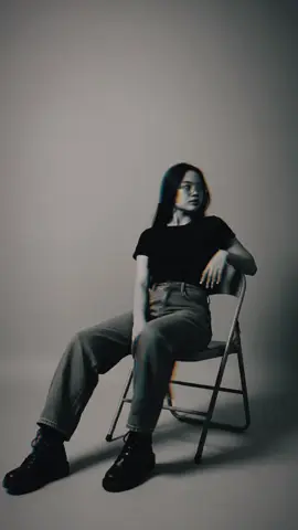 1. Open Gemini AI 2. Upload image 3. Paste the promt Promt: Use a model (the person in the image) to create a black and white studio photo featuring a young women sitting casually on a metal folding chair with his legs cross. She's wearing a denim baggy jeans, black tshirt and black boots. The lighting is soft and minimal, producing sharp shadows and a moody atmosphere. She pose is relaxed, slightly leaning with one hand on the chair's backrest, his face turn to the side. The background is plain with a simple and modern aesthetic. Copy her face and her facial expression and make a clean. #CapCut #geminiai #aigenerated #fypシ #viral 