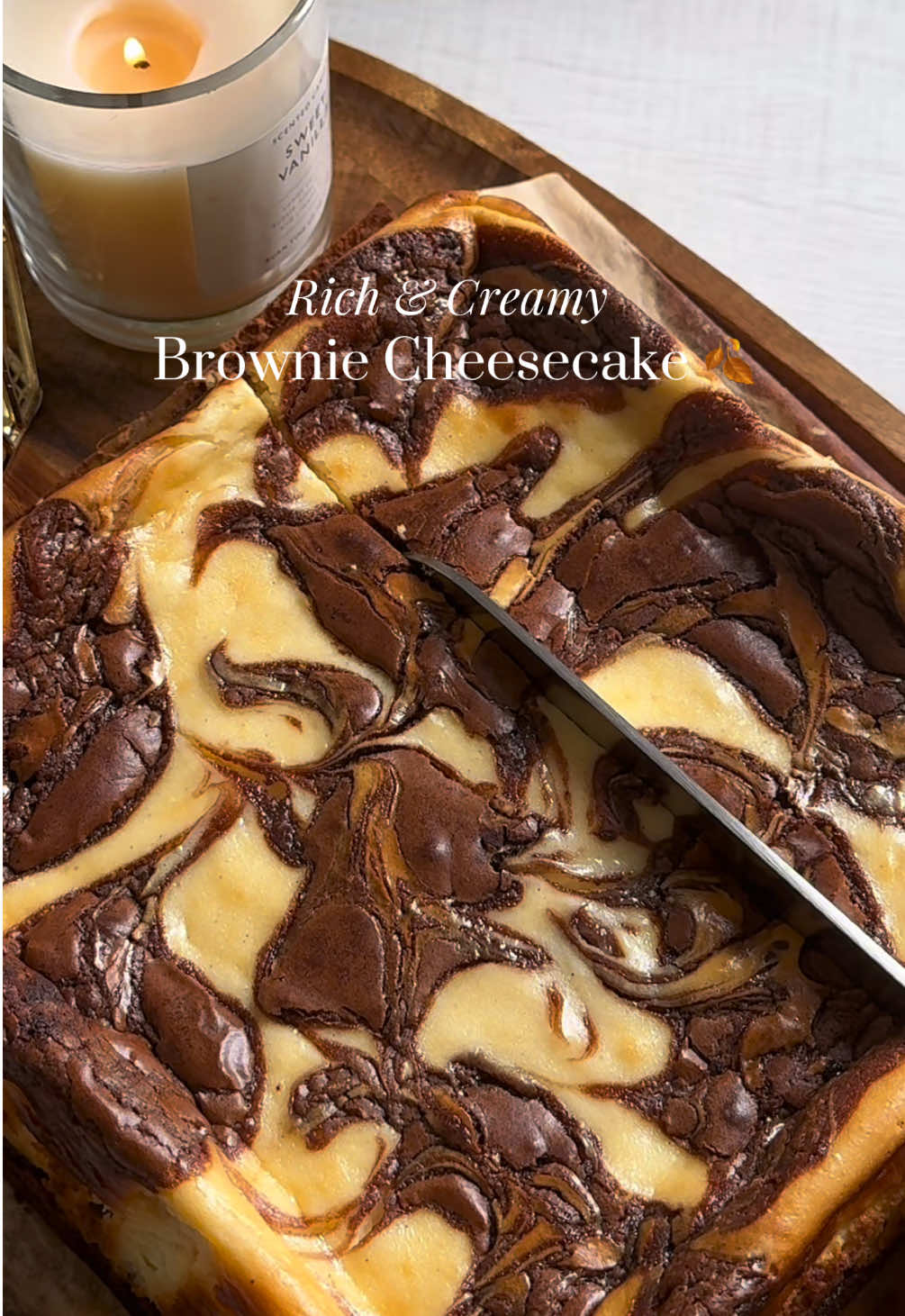 A decadent mix of fudgy brownie and creamy cheesecake, this dessert is pure comfort—perfect for curling up with on a cozy evening Brownie recipe  • 110g salted butter  • 200g milk chocolate  • 2 eggs room temp • 125 brown sugar • 50g plain flour • 25g cocoa powder  • 1/2 tsp baking powder  • 1 tsp vanilla extract  • pinch of salt  Method: 1.	Heat oven to 175°C. Line a 20 cm tin. 	2.	Melt 110 g butter with 200 g milk chocolate; cool slightly. 	3.	Whisk 2 eggs, 125 g brown sugar, 1 tsp vanilla. 	4.	Stir in melted chocolate. 	5.	Fold in 50 g flour, 25 g cocoa, ½ tsp baking powder, pinch salt. Cheese cake  • 450g cream cheese  •105g caster sugar  •2 eggs room temperature  • 3 tsp vanilla extract  Method: 	2.	Beat 450 g cream cheese with 105 g caster sugar until smooth. 	3.	Mix in 2 room-temp eggs, one at a time on low speed until its just combined dont over mix 	4.	Add 3 tsp vanilla and blend until creamy. •Gently pour the cheesecake batter over the brownie batter, smoothing the top without mixing the layers  •Add two tablespoons of leftover brownie batter on top of the cheesecake layer.	•Create a swirl design using a skewer or toothpick by dragging through the brownie dollops for a marbled effect   bake at 175c for10 min, then reduce heat to 170 °C and bake for 30–35 min until the cheesecake is just set and has brown edges  #cheesecake #brownies #desserts #asmrvideo #browniecheesecake 