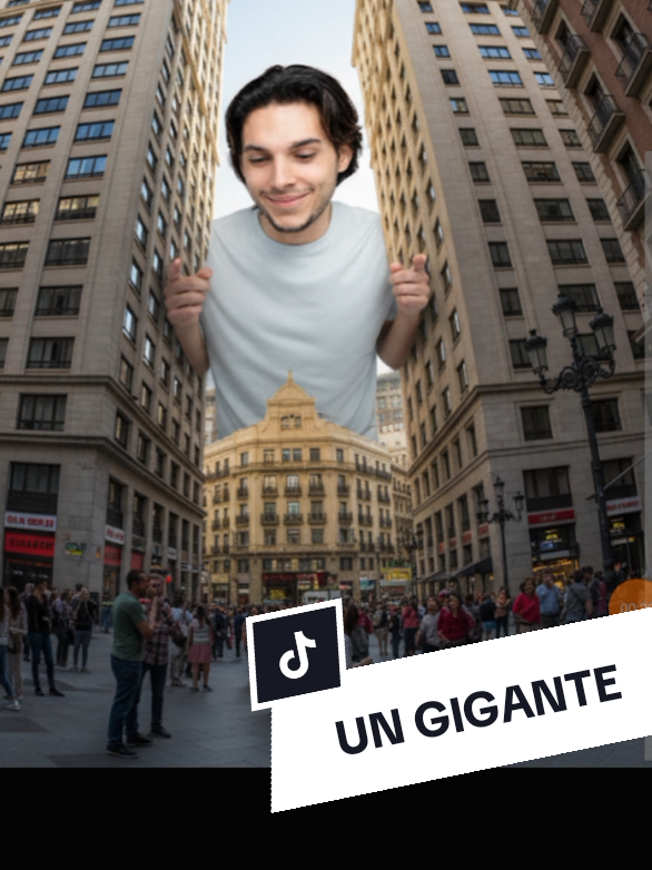🔰UN HOMBRE GIGANTE SIGUENOS Y DEJANOS UN CORAZON PROMPT: Generame una imagen con la fisionomía de la imagen de gran estatura, asoma tímidamente desde detrás de uno de los rascacielos con la mitad de su cuerpo y los hombros visibles agarrando los lados de los rascacielos, como si se escondiera o observara con Desprendía curiosidad y una leve sonrisa, mientras observaba la escena. Contexto y perspectiva: Foto ultrarealista, tomada desde el suelo en una plaza, con un objetivo gran angular, mirando hacia arriba. El espectador se encuentra al nivel del suelo, percibiendo la enorme figura del joven detrás del edificio. Los rascacielos circundantes, debido a la distorsión del objetivo, parecen diminutos y curvados. Se aprecian detalles urbanos como ventanas, fachadas y otros elementos arquitectónicos en primer y segundo plano. Se ven carteles en idioma español alrededor de la plaza. Ambiente y detalles: Los peatones en la plaza parecen diminutos y reaccionan con una mezcla de confusión y asombro, algunos señalando y susurrando. El bullicio de la ciudad contrasta con la misteriosa presencia de este gigante. #gemini #inteligenciaartificial  #aiphoto #prompt #fyp 