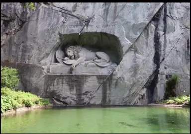 The Lion of Lurcern is a devastating sculpture made in honor of fallen Swiss guards of the French Revolution. The lion is impaled and captured in the midst of dying, laying on a shield. Few artworks capture mourning like this one, the statue is carved out of a stone face with a pond dividing the viewer from the wounded lion, creating a sense of yearning to comfort the creature which is so far removed from any warmth. #quote #fyp #edit #sculpture #lionoflucerne  