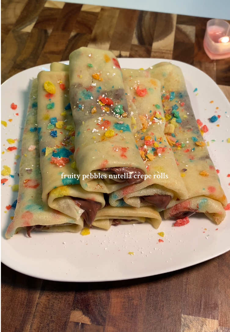 fruity pebbles & nutella crepe rolls 🍭 crepes >  2 cups milk 1 cup flour  3 tbsp unsalted butter, melted (let cool down a bit before mixing)  1 or 2 tbsp sugar 2 large eggs  vanilla (optional) fruity pebbles  > let cereal sit in milk before mixing into batter  > refrigerate batter for 2 hours or overnight  !! make sure you don’t overmix batter or your crepes will be rubbery  #baking #asmr #Recipe 
