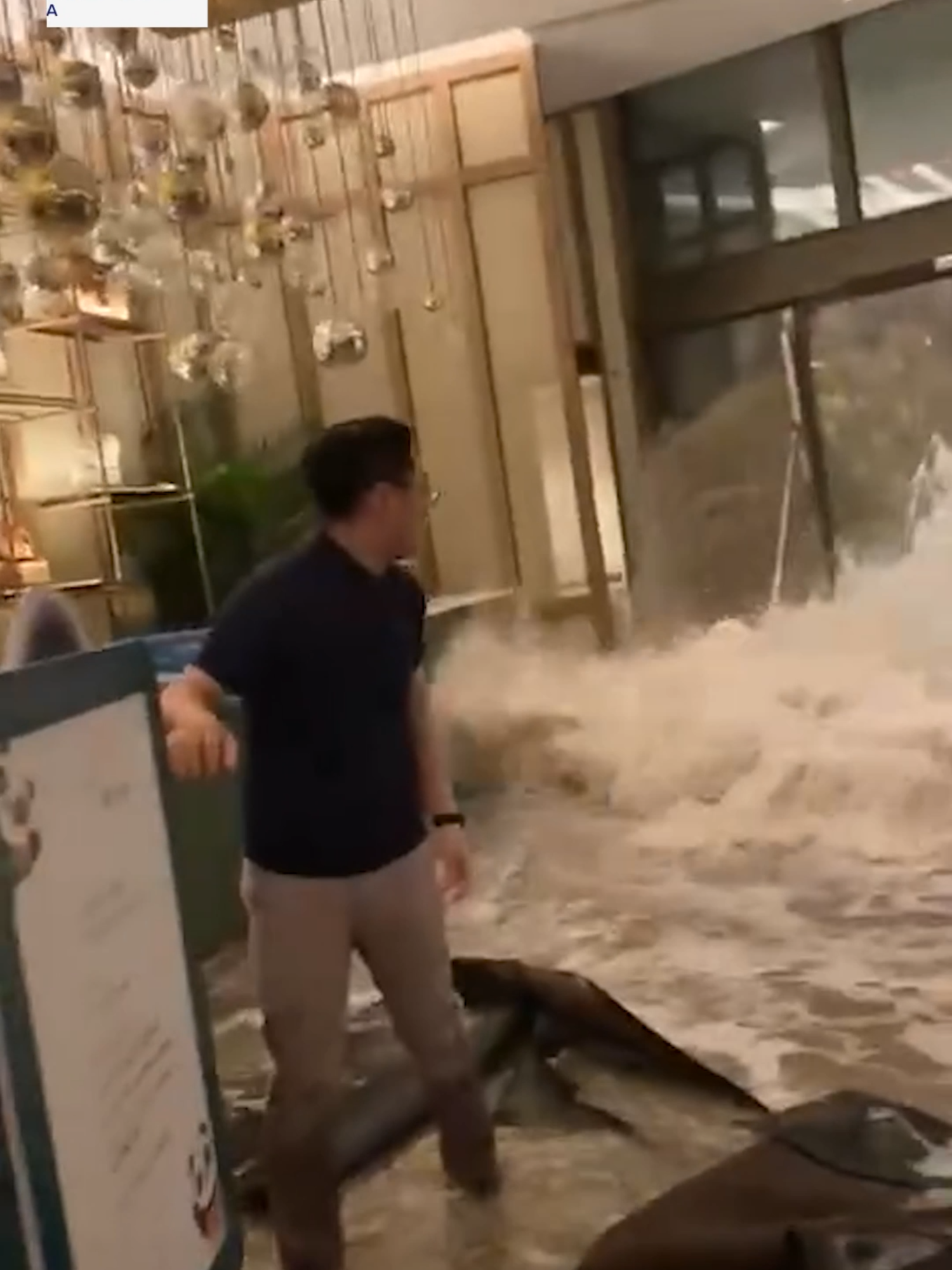 Video circulating online shows the dramatic moment floodwaters smash through the doors of a hotel in Hong Kong, as Super Typhoon Regasa lashed the territory. #abcnews #news #ragasa