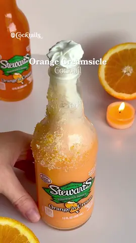 Dessert in a bottle.🍊🍹 Ingredients: - Stewart's Orange & Cream Soda - orange zest and sugar for the rim - 1.5 oz. vodka - 1 oz. heavy cream (pour very slowly) - .5 oz. sweetened condensed milkwhipped cream to garnish #stewarts #orangesoda #orangecreamsicle #cocktail #boozy  