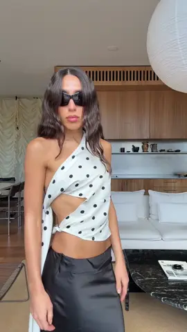 dressed to the 9s. @cameliafarhoodi  camelia wears the REVIVAL CAMI in CREAM POLKA and the ANCHORED MIDI SKIRT in NOIR.