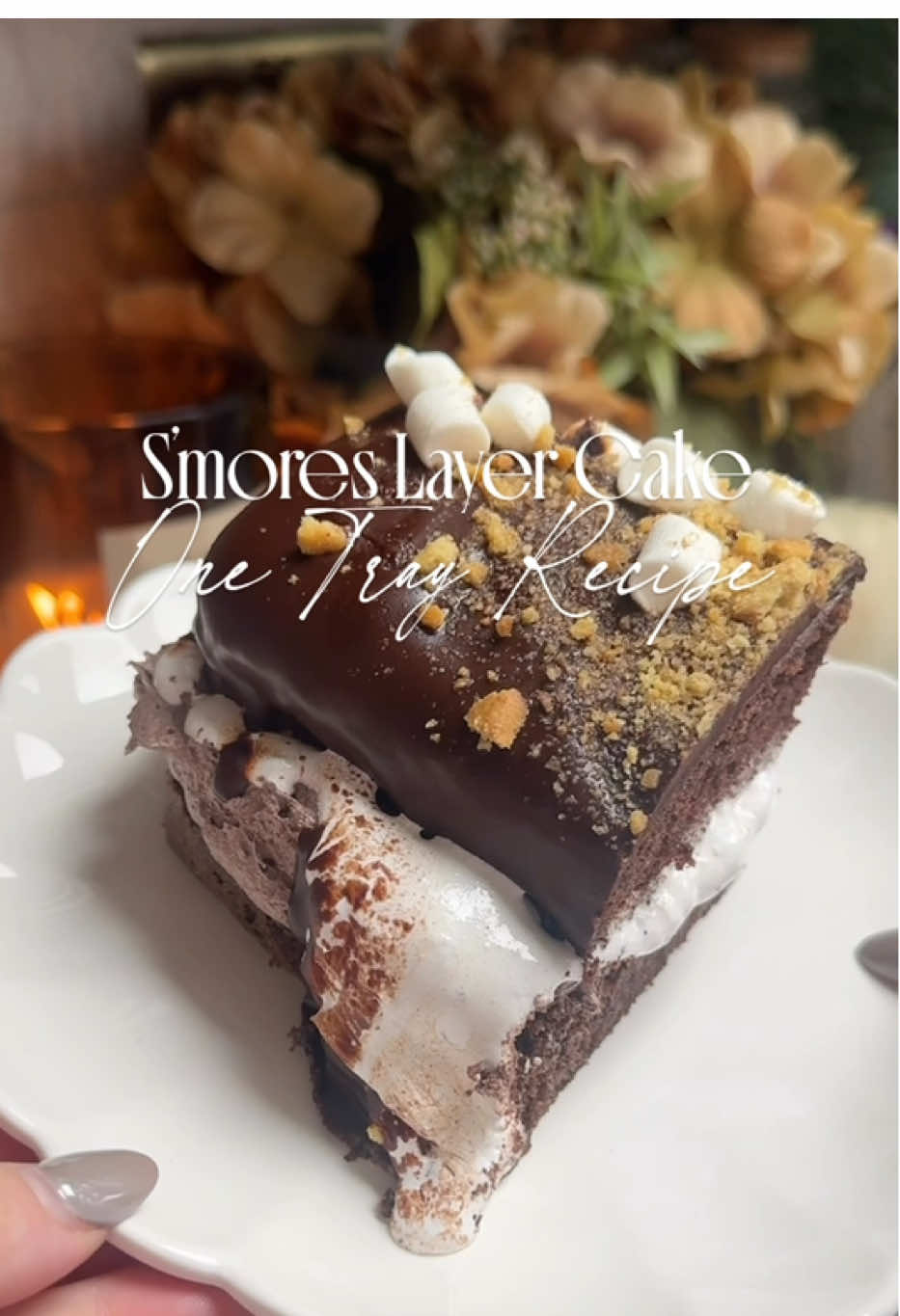 🔥🍫 S’MORES TRAY CAKE 🍫🔥 Think rich layers of chocolate sponge, gooey marshmallow fluff and a glossy ganache topping, finished with mini marshmallows + digestive crumbs (graham crackers for my US pals!). Honestly, the marshmallow was oozing out the sides by the end and it was soooo satisfying 😍 The recipe: Chocolate sponge 	•	100g cocoa 	•	200g unsalted butter 	•	200g caster sugar 	•	6 eggs 	•	200g self raising flour Frosting 	•	150g dark chocolate 	•	100ml double cream 	•	75g butter 	•	250g icing sugar 	•	2 tbsp cocoa powder Ganache 	•	200g dark chocolate 	•	200ml double cream Extras 	•	1 jar marshmallow fluff 	•	Mini marshmallows 	•	Digestives/graham crackers, crushed ✨ Method: Firstly Melt butter & chocolate. Whisk your eggs and sugar until pale and foamy, then fold in flour and cocoa!  Once combined Bake in a 10x15 tin (lined) at 140°C until evenly baked! Cool, then slice in half for two layers. For the frosting: I melt chocolate and cream, I start whipping my butter nice and fluffy, then beat in icing sugar. Slowly add your chocolate until it’s combined. Spread frosting over your first sponge layer. Dollop over marshmallow fluff generously, then sandwich with the second layer. For the ganache: heat cream, pour over choc, stir until glossy. Pour over the cake, smooth it around and let it drip. Top with mini marshmallows & crumbled digestives (or grahams) ✨ Slice, watch the fluff ooze, and dig in 🥹🔥 Honestly you won’t regret making this one 😍 #chocolate #chocolatecake #autumn #smores #Recipe 