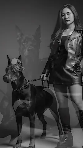 #CapCut  prompt : edit foto ini menjadi foto santai di studio foto seperti sedang pemotretan, foto hitam putih bergaya edgy dengan nuansa misterius, dia mengenakan outfit serba hitam, tanktop di padu dengan jaket kulit croptop dan rok mini serta sepatu boots hak tinggi selutut, dia memegang tali anjing doberman disampingnya, jangan merubah wajah sedikitpun. #geminiai #fyp 
