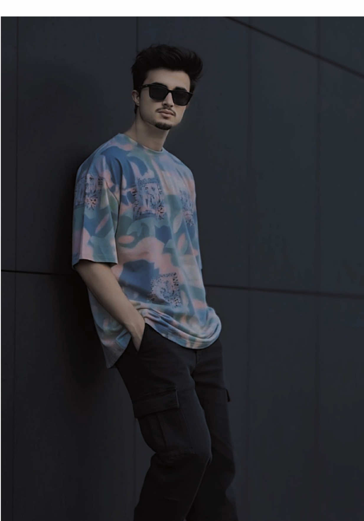 1. Gemini 2. Nano Banana 🍌 3. Upload photo  1st. Prompt: Create a cinematic ultra-realistic full-body portrait of a stylish young man leaning casually against a modern dark wall outdoors. Use the uploaded photo exactly, keeping the original face and shape without alteration. He has neatly styled black hair, a trimmed beard, and wears dark sunglasses. Outfit: a relaxed oversized graphic T-shirt in pastel tones, paired with baggy cargo pants and chunky white sneakers. 2ndPrompt:- Create a photo of me  posing against a dark, street background with stone and brick elements, similar to the provided image.Face should look real 100% of real image provides. I should be leaning against a low stone wall or structure, looking towards the camera side with a confidence.I should be wearing a black loose Shirt, light grey cargos, and black and white colour shoes. The lighting should be natural and slightly diffused, giving a moody yet clear feel.left hand touching the hair 3rd: Prompt: Ultra-realistic photo of a confident man a full body  6 feet height (followed by given picture face Ultra unchanged) leaning against a white textured wall in natural sunlight, wearing an unbuttoned beige linen shirt, black relaxed baggy jeans pant , stylish sunglasses, and a wristwatch. Sharp shadows, detailed textures, sun-kissed skin, minimal summer fashion, editorial street style look. 4th. Prompt: Hyper-realistic 8k portrait of a 21-year-old, 5'8