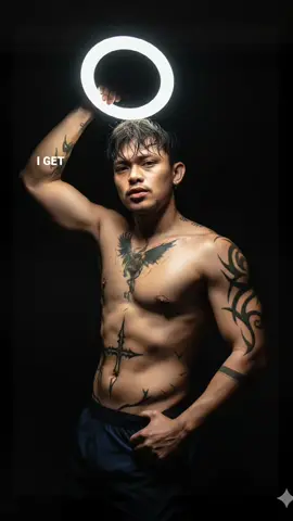 Ultra-high resolution, portrait ratio 9:16. A young Asian man, height 165 cm, weight 65 kg, yellow-brown skin tone.exposing defined abs, similar to the provided reference photo dont forget to copy the tattoo's. In a completely dark room, he is shirtless, holding a glowing 25 cm diameter ring light with one hand, placing it right beside the right side of his face. The ring light casts a bright circular glow directly across his skin, illuminating his pores, sweat droplets, and sharp facial features in hyper-realistic detail. His other hand grips the back of his neck firmly, creating a strong editorial fashion pose. With one arm raised, thick natural armpit hair is visible beneath his low-cut stance. His wet, messy side-parted hair falls across his forehead, individual strands highlighted by the glow. The lighting creates dramatic contrast: the right side of his face and body glows vividly while the opposite side fades into shadow. His expression is intense, raw, and powerful, like a world-class model in a high-fashion editorial shoot. Background fully black, full color. #makeitviral #CapCut #gemini #prompt #chatgpt 