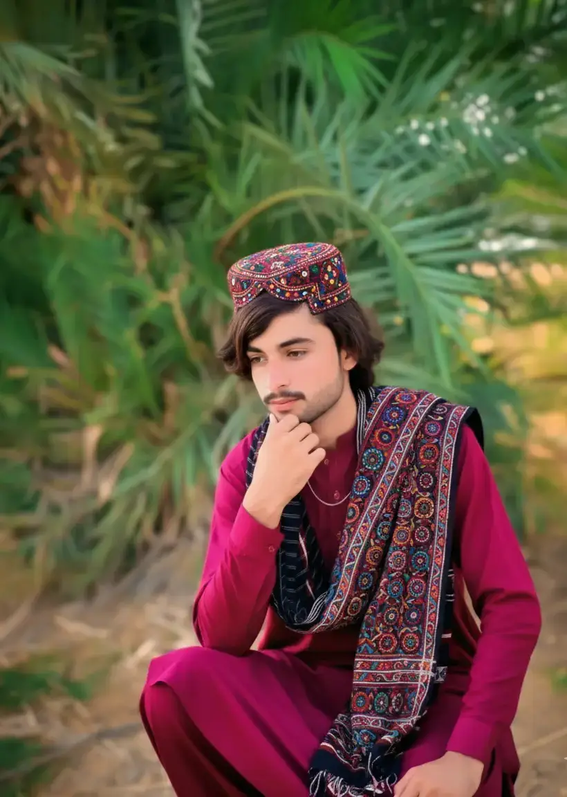 A traditional culture Sindhi man sitting and thinking deeply, wearing a classic Sindhi topi with detailed embroidery, ajrak draped gracefully on shoulder, dressed in taditional Sindhi shalwar kameez. Natural soft light realistic skin texture, cinematic color authentic Sindhi culture vibe, high-resolution portraits photography style, ultra-detailed face 100, sharp focus, background slightly blurred for depth