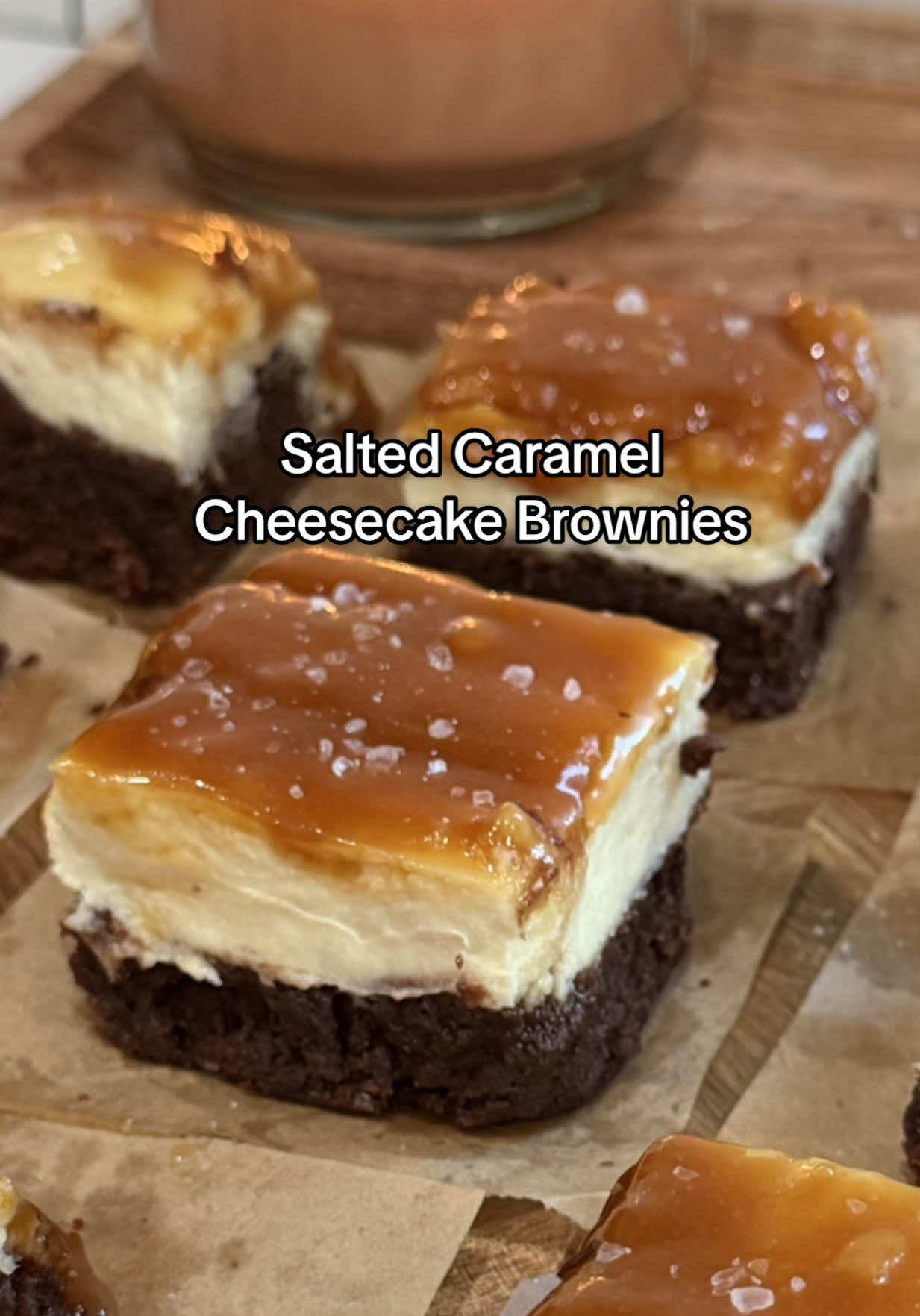Ooey gooey caramel with cheesecake & fudgey brownie= the most decadent trio✨✨  RECIPE: For the brownie base 1/2 cup unsalted butter, melted 1 cup granulated sugar 2 large eggs 1 tsp vanilla extract 1/2 cup unsweetened cocoa powder 1 cup all-purpose flour 1/4 tsp baking powder 1/4 tsp salt For the cheesecake layer 450g/16oz cream cheese, softened 1/4 cup granulated sugar 1 large egg 1 tsp vanilla extract For the caramel topping: 1 cup sugar  3-4 tbsp butter  1/4 cup heavy cream  1/2 tsp vanilla Flaky sea salt, for sprinkling 1. Preheat oven & Set to 350°F (175°C). Line an 8x8-inch baking pan with parchment paper. 2. Make the brownie base:  In a mixing bowl, whisk together melted butter and sugar. Add eggs and vanilla. Stir in cocoa powder, flour, baking powder, and salt until just combined. Spread evenly in prepared pan. 3. For the cheesecake layer: Beat cream cheese and sugar until smooth. Add egg and vanilla, mixing until creamy. Spread over the brownie batter. 4. Bake 30–35 minutes, or until cheesecake layer is set and just slightly golden. Let cool completely in pan. 5.  Once cooled, spread a layer of caramel sauce evenly over the cheesecake. Sprinkle with flaky sea salt. 6. Refrigerate at least 1-2 hour for clean slices.  For CARAMEL SAUCE: 1. In a saucepan over medium heat, add the sugar. Stir constantly with a heatproof spatula or whisk as it melts into a golden liquid (it will clump first, then smooth out). 2. Once fully melted and amber-colored, carefully add butter. It will bubble up. Stir until fully combined. 3.  pour in the heavy cream while stirring. Again, it will bubble vigorously. Keep whisking until smooth. 4. Remove from heat, stir in sea salt. Let it cool for 10–15 minutes before pouring over the cheesecake layer. #brownies #cheesecake #saltedcaramel #cheesecakerecipe #fallbaking 